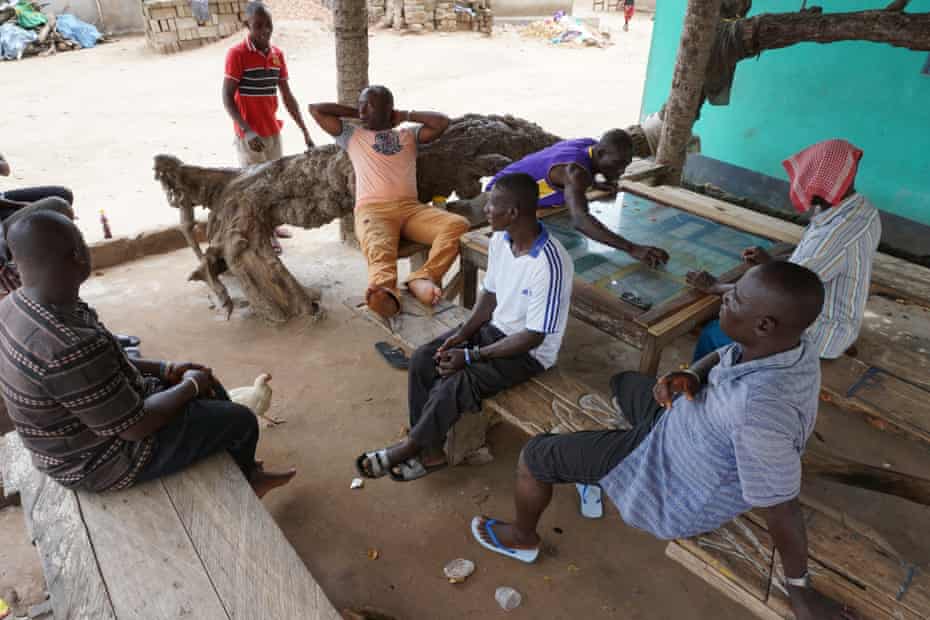 Men relax in the middle of the day in Nyanyano. Most work as fishermen and when they are not working they rarely help with household chores