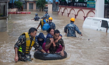 Nepalese soldiers rescue locals from flood waters in Kathmandu, Nepal, on Friday.