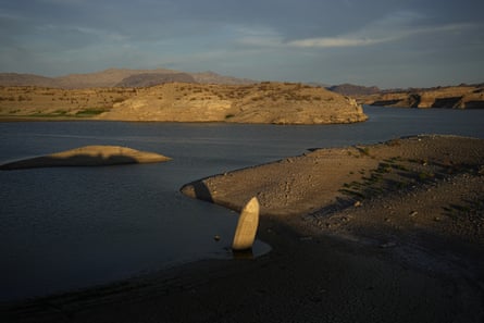 A formerly sunken boat sits upright into the air along the shoreline of Lake Mead on 10 June 2022.