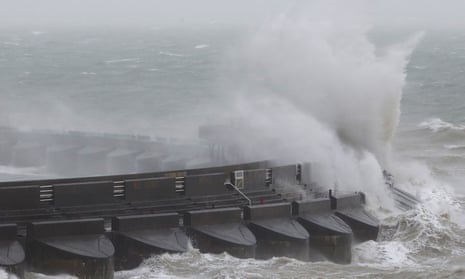 Waves crash over the marina wall in Brighton during Storm Doris