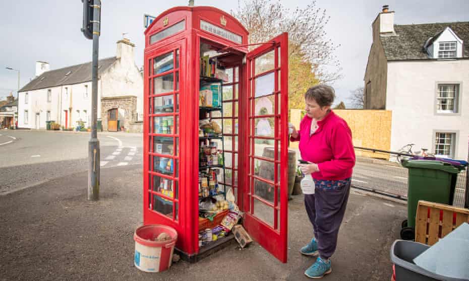 Susan Crawford, a founder of the phone box community food larder in Muthill, Perthshire, checks the provisions.