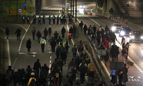 Protesters walk along the A4032 which leads to the M32 in Bristol