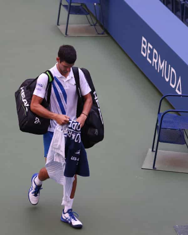 Djokovic walks off after being defaulted for inadvertently striking a lineswoman with a ball at the 2020 US Open in September.