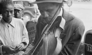 A man playing a violin in the street in West Memphis, Arkansas.
