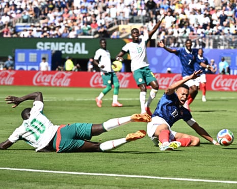 Senegal's Sadio Mane challenges France's Kylian Mbappe in the penalty area leading to a VAR review.