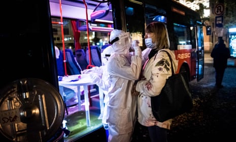 A medic tests a woman for coronavirus during nationwide testing in Bratislava, Slovakia.