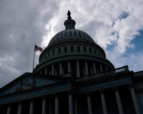 Clouds cast the US Capitol building into shadow