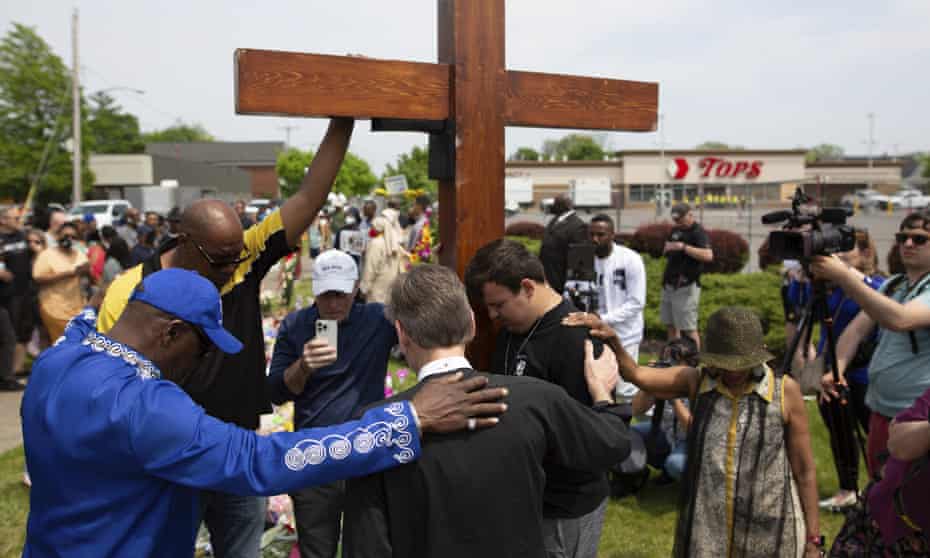 people put hands on each others' backs as they pray