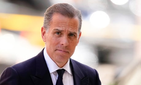 Hunter Biden in black suit and tie with white shirt.