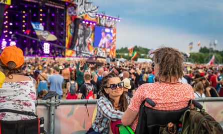 Festivalgoers in wheelchairs watch a band in the open air at Pol’and’Rock, Poland.
