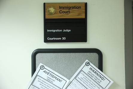 A sign and papers on a cork board