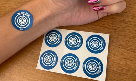 blue sticker with circles on it on a wrist