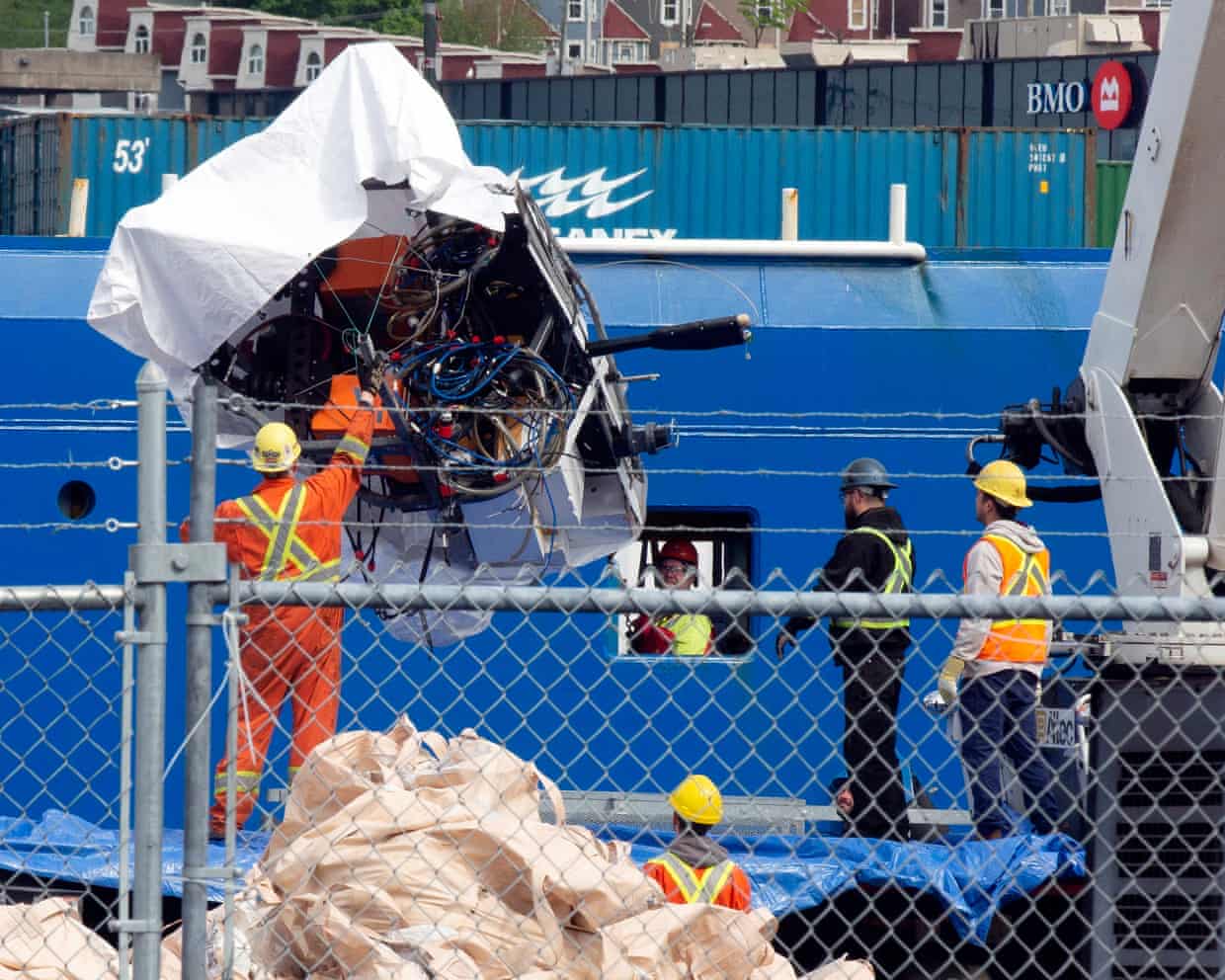Recovered debris from the Titan submersible is unloaded from a ship in Newfoundland