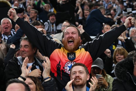 Fans of Newcastle United celebrate as Miguel Almiron of Newcastle United (not pictured) scores the team's first goal during the UEFA Champions League match between Newcastle United FC and Paris Saint-Germain at St. James Park.