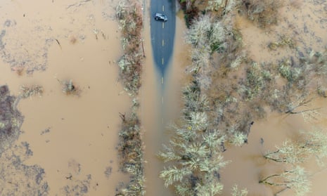 A vehicle turns around on a flooded road in Sebastopol, California.