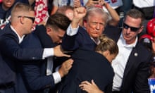 US Republican candidate Donald Trump is seen with blood on his face surrounded by secret service agents as he is taken off the stage at a campaign event at Butler Farm Show Inc. in Butler, Pennsylvania, on July 13, 2024.