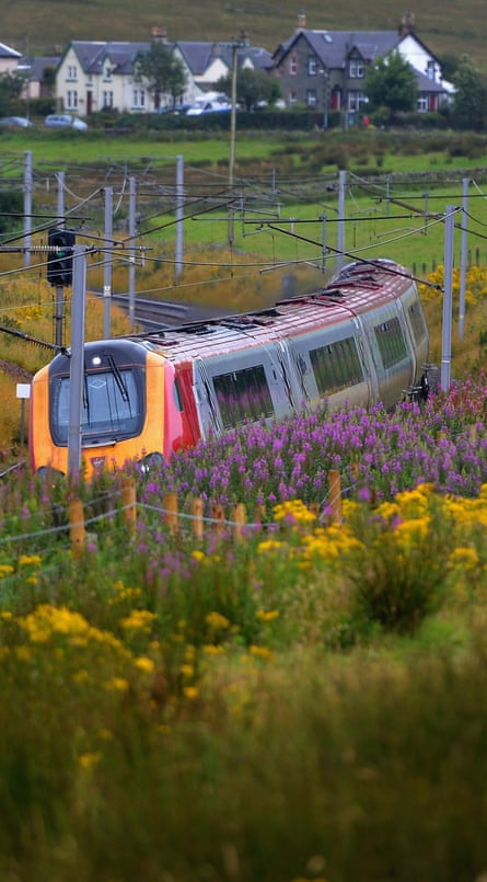 A Virgin train passes along the west coast mainline near Abington in Scotland.