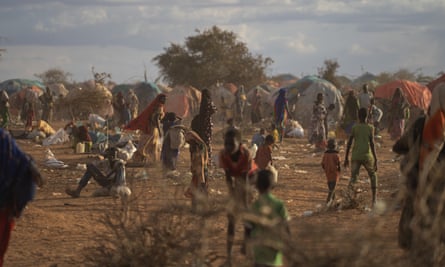 People gather at a displacement camp on the outskirts of Dollow, Somalia, on Monday, Sept. 19, 2022.