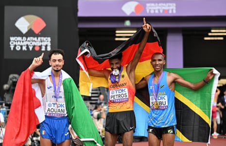 Gold medallist Alphonce Felix Simbu of Tanzania (right), silver medallist Amanal Petros of Germany (centre) and bronze medallist Iliass Aouani of Italy pose after the men’s marathon final at the 2025 World Athletics Championships