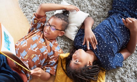 Two brothers on the floor, one reading