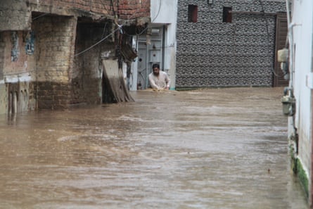 A resident navigates through a flooded street in a neighbourhood of Mingora, the main town in the Swat Valley.