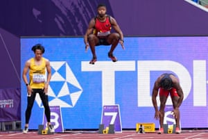 Marcos Santos of Angola leaps into the air while warming up for a men’s 100m preliminary round heat.