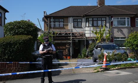 A police officer guards a cordon outside a house after a sword attack on April 30, 2024 in Hainault. After a vehicle was driven into a house, a suspect went on to attack other members of the public and two police officers near to Hainault Tube Station in North East London. A 36-year-old man was arrested at the scene and is in custody.