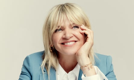 Zoe Ball, smiling, face resting in her hand