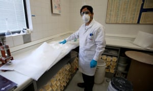 A worker takes samples of lithium carbonate processed from the Rockwood Lithium mine on the Atacama salt flat.