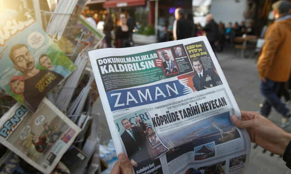A man reads a copy of Zaman newspaper