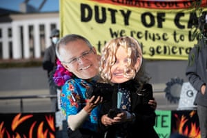 Margaret Clough in a Sussan Ley mask with another protester dressed as Scott Morrison