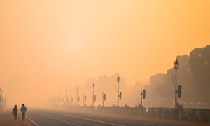 Two men walk along Rajpath amid smoggy conditions in New Delhi last month.