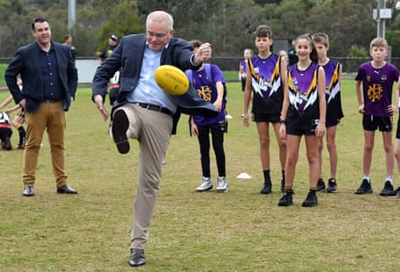 Scott Morrison kicks a ball at a Melbourne sports club during the 2022 election campaign