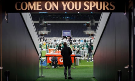 Former NFL player and now TV pundit Osi Umenyiora watches the game in the rain from the safety of the tunnel during the match NFL Academy against De La Salle Spartans.