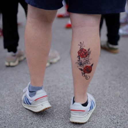 A man with a tattoo of red roses on his leg outside the stadium before the Women’s Rugby World Cup 2025 semi-final match between England and France.