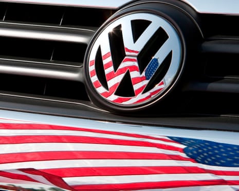 A US flag in front of the Volkswagen logo