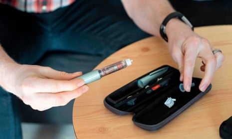 A diabetic prepares his insulin pen.