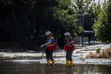 Emergency workers respond as flood waters rise in central Kherson.