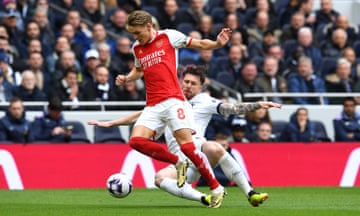 Martin Odegaard of Arsenal is challenged by Pierre-Emile Hojbjerg of Tottenham Hotspur.