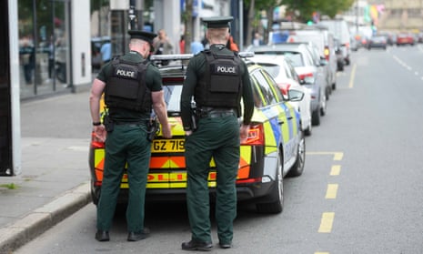 PSNI officers behind police vehicle
