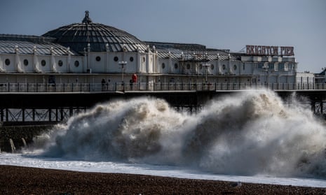 Waves crash on the beach next to Brighton pier as high winds continue following Storm Ciara