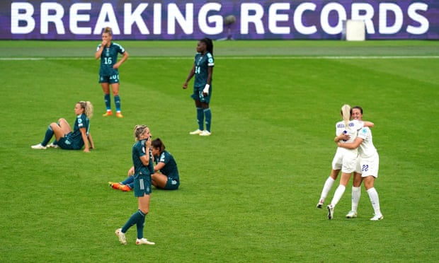England’s Alex Greenwood and Lotte Wubben-Moy celebrate victory as Germany players look dejected.