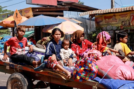 A family including children flee their homes near the Cambodian border