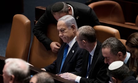 Prime Minister Benjamin Netanyahu is surrounded by lawmakers at a session of the Knesset, Israel’s parliament, in Jerusalem, Israel, on 24 July.