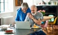 Models recreated the image of a retired couple looking at a laptop on a kitchen island