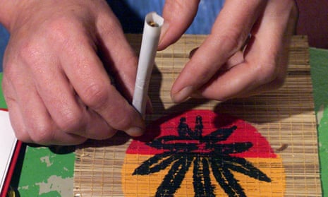 a person rolls a joint
