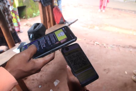 A man holds a mobile phone in his hand.