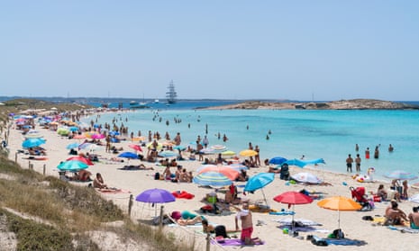 sunbathing on the Playa de Ses Illetes, Balearic Island of Formentera.