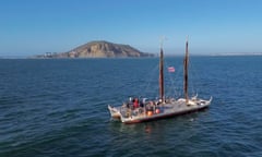 A double-hulled, twin-masted Polynesian sailing canoe about 19 metres long