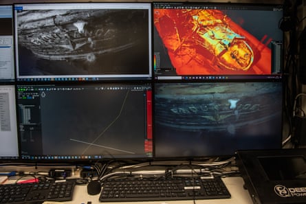 Four images on screens indicating a shipwreck and its location above a keyboard